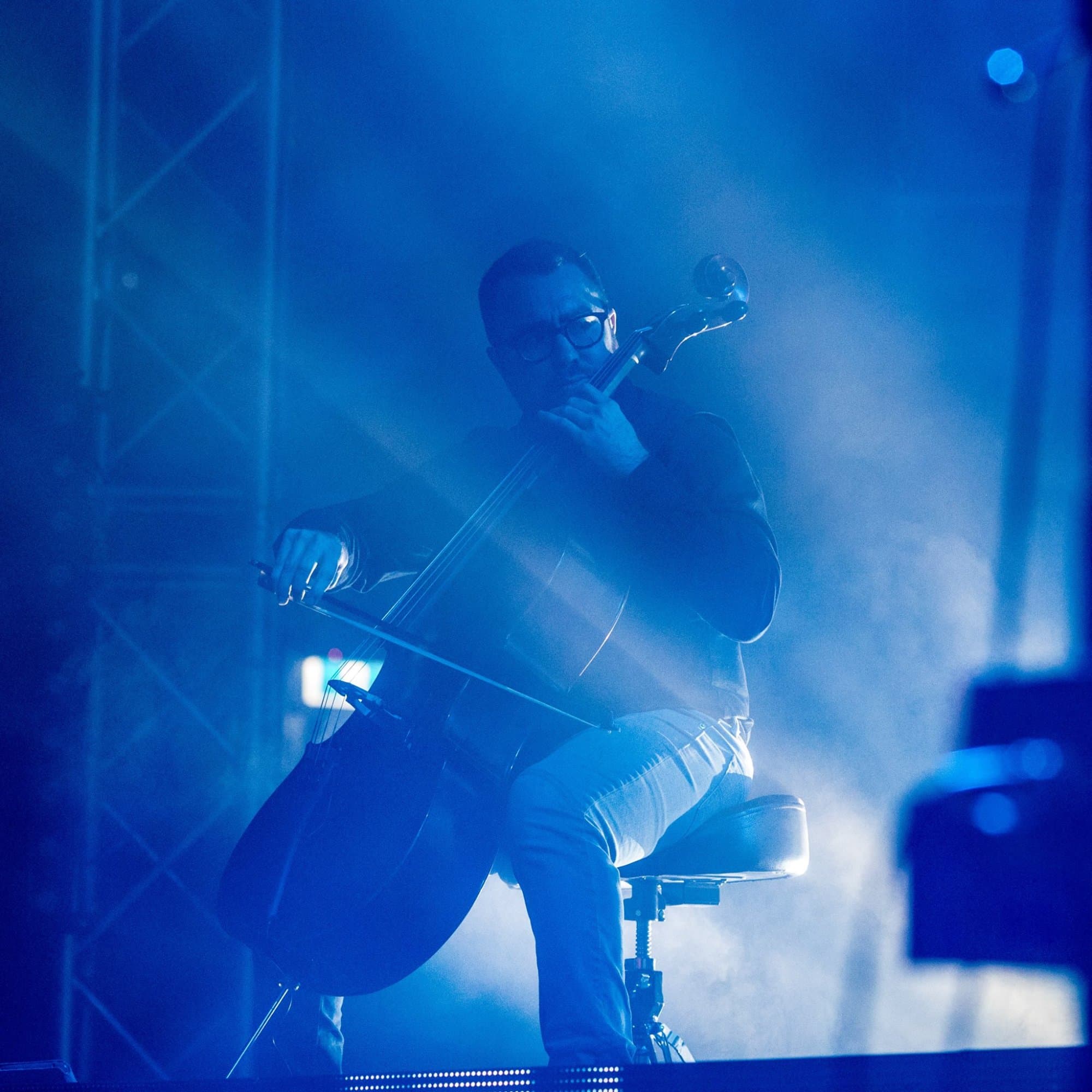 Solo cello performance with dramatic blue lighting