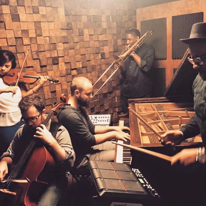 Ensemble performance with wooden wall backdrop